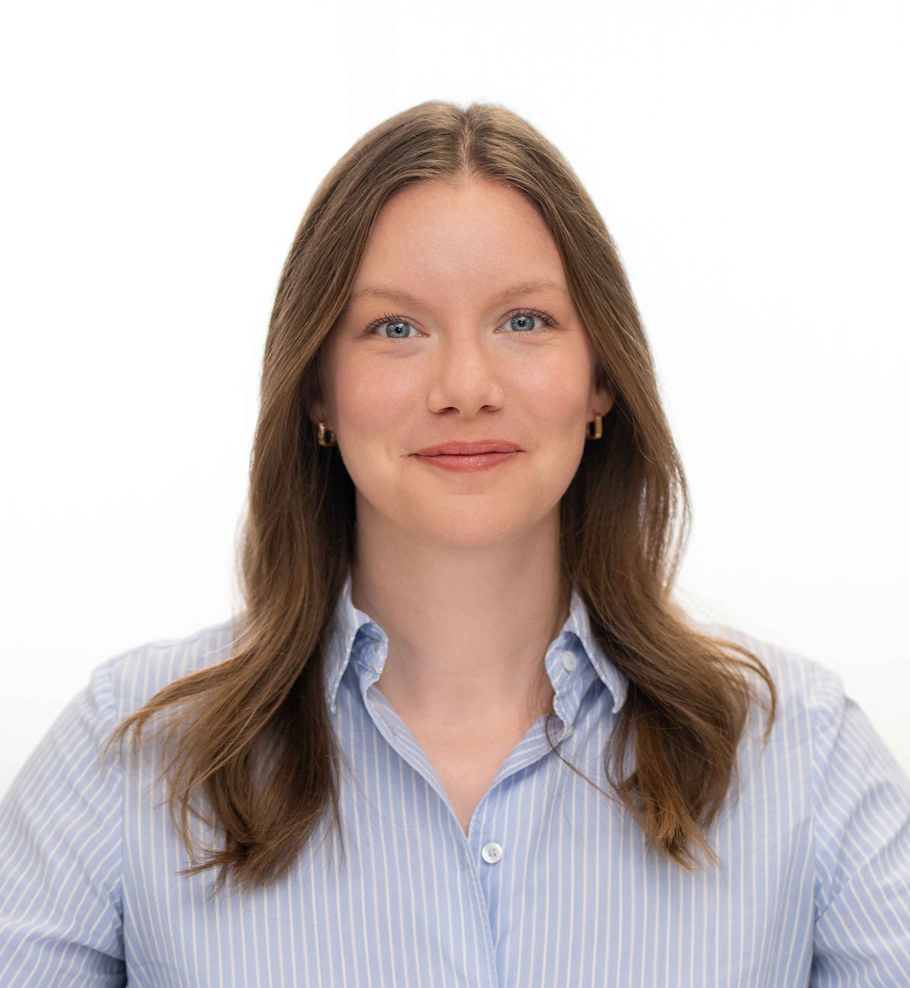 Corporate headshot of a woman in a blue striped shirt