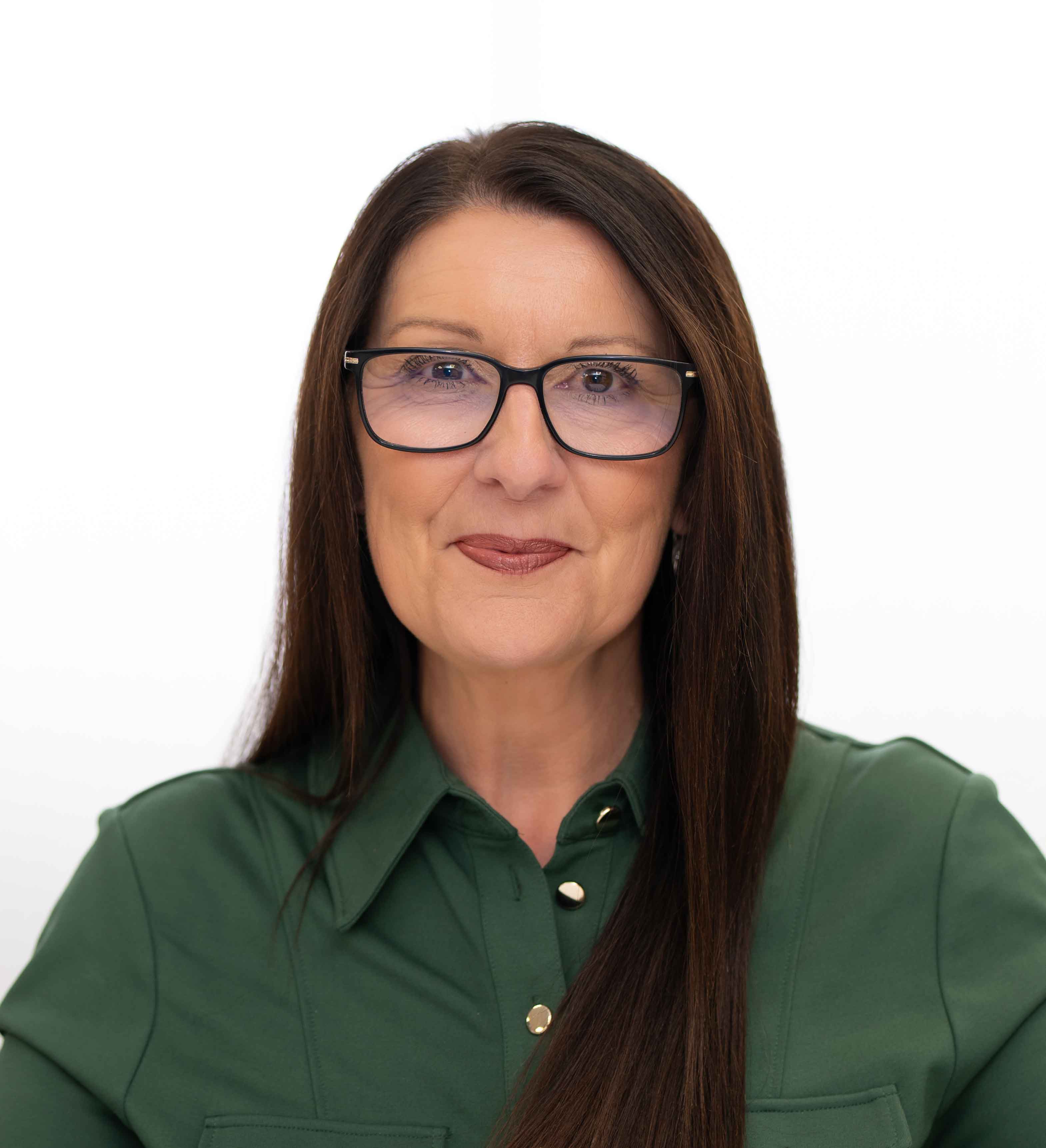 Corporate headshot of a woman in a green shirt